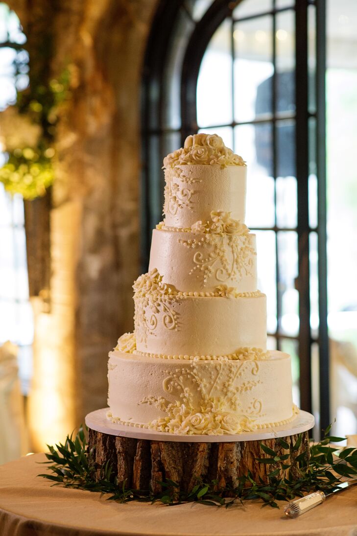 Ashley and Kyle served a four tier, gluten-free, wedding cake with white Bavarian cream filling and buttercream frosting decorated with delicate scrolling. "We were going to make one of the layers fake, but decided at the last minute to make it another full layer. Lucky for us, because every piece was eaten!" says Ashley.