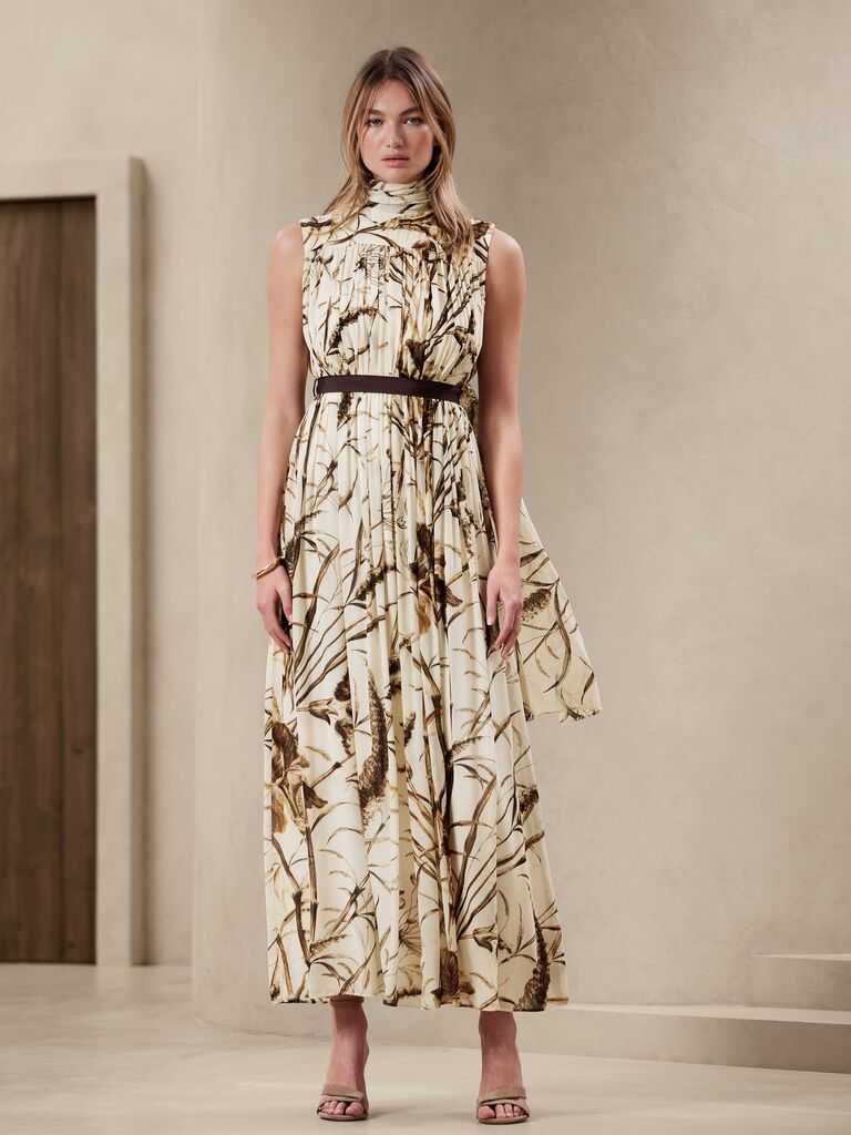 Model wearing long botanical maxi dress with belt