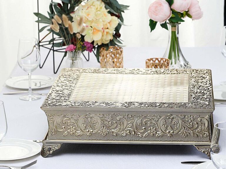 Ornate gold square wedding cake stand with embossing