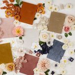 collection of velvet vow books for wedding in various colors with matching flowers