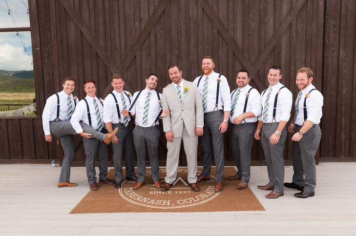 The groomsmen wore charcoal gray pants with navy suspenders and a navy and green ties.