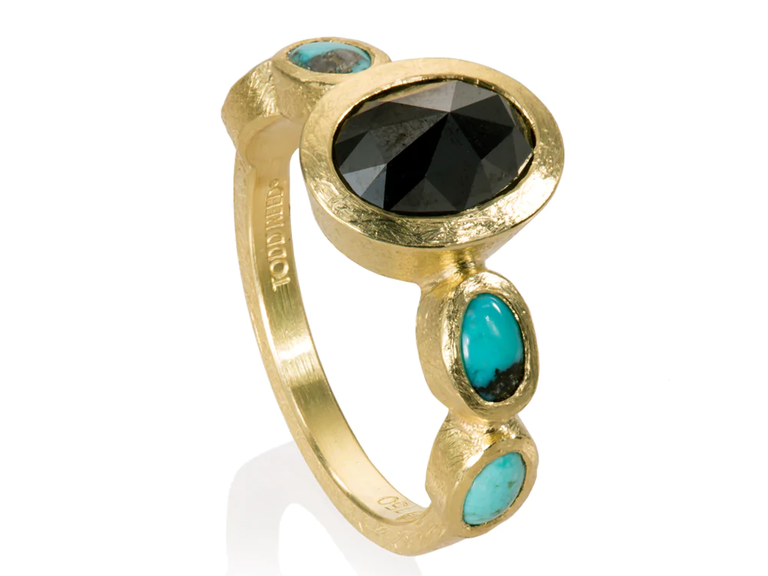 This geometric engagement ring with a black diamonds and turquoise stones will bring a modern edge to your wedding day.