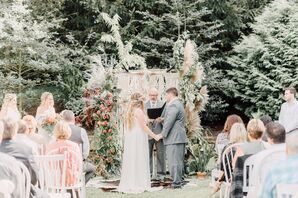 Bride and Groom Wed Underneath a Wedding Arch Made of Greenery, Pampas Grass and Protea