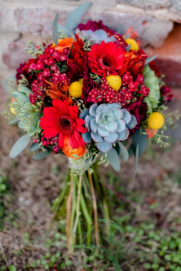 Maggie carried a bouquet of yellow billy balls, orange ranunculus, burgundy dahlia, cottage red yarrow, mint green succulents, green seeded eucalyptus, red mini gerbera daisies, orange celosia and hot pink bouvardia. “The bouquets were bright and semiautumnal but just looked colorful and happy,” she says.
