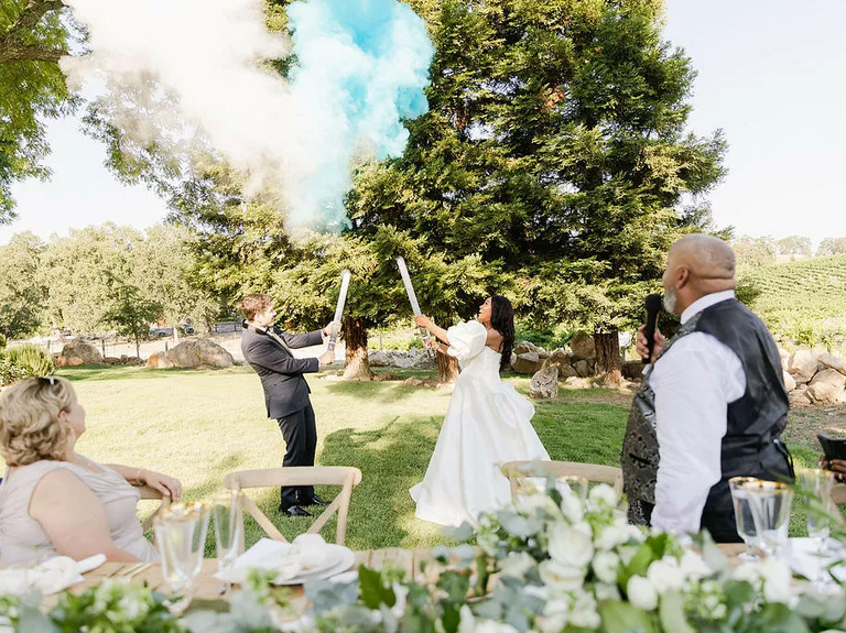 Fun smoke bomb baby reveal for your wedding reception