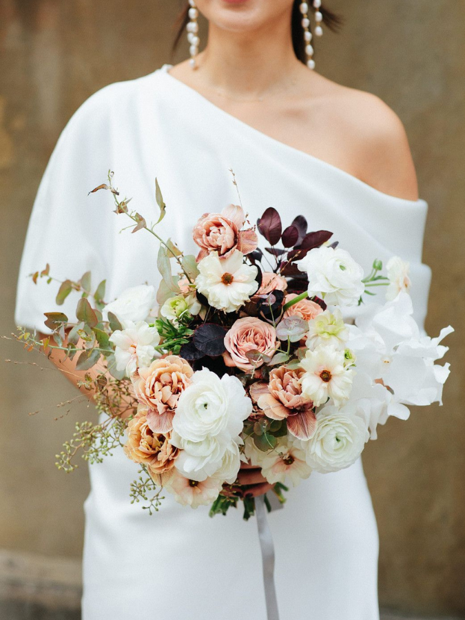 Bride holding fall wedding bouquet