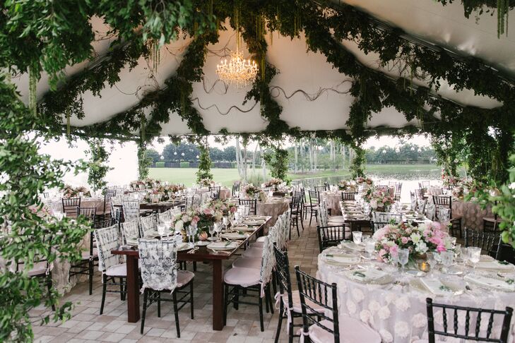 “One thing to note about our reception was that everything was created from scratch,” says Joyce. Her and Jay designed the tented reception two months before their wedding. It was decorated with chandelier lighting, mixed vintage silver chargers, grape vine and eucalyptus garlands, romantic floral centerpieces and dark chiavari chairs.
