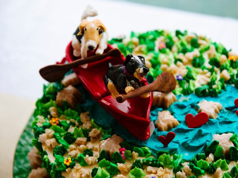 Couple's dog canoeing on a Vermont river as cake toppers. 