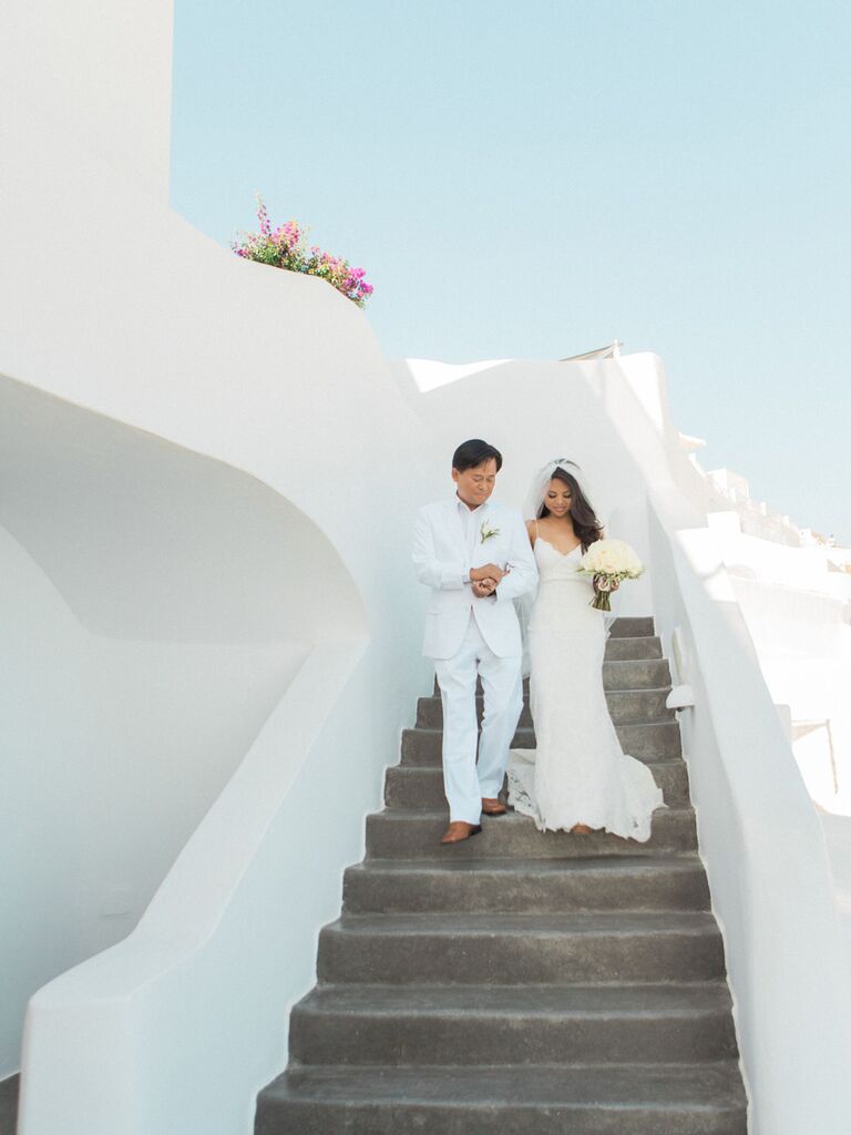 Bride walking down the aisle with father in Greece