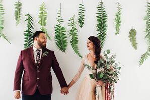 Groom in Burgundy Suit and Bride with Large Eucalyptus Bouquet