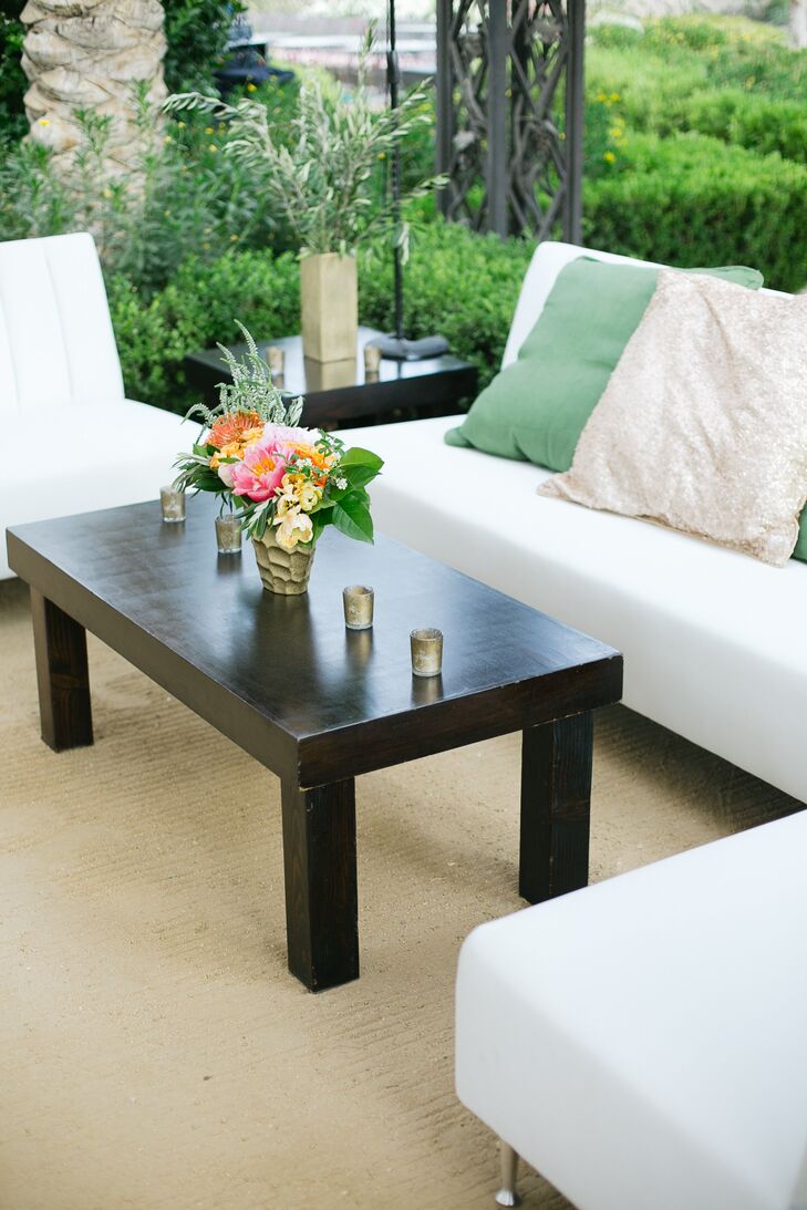 Green and shimmery gold throw pillows, gold accents and bright florals dressed up the sleek modern cocktail lounge.