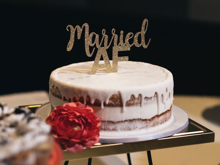 funny one tier wedding cake with drip vanilla icing and married AF cake topper in gold glitter letters