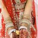 Traditionally, the day before an Indian wedding, the bride has a mehndi party. All the women have henna done on their hands and feet as a way to signify the bride's transformation from a single woman to a married woman. Vineeta wore traditional gold and red bangle bracelets up her arms for the wedding as well.
