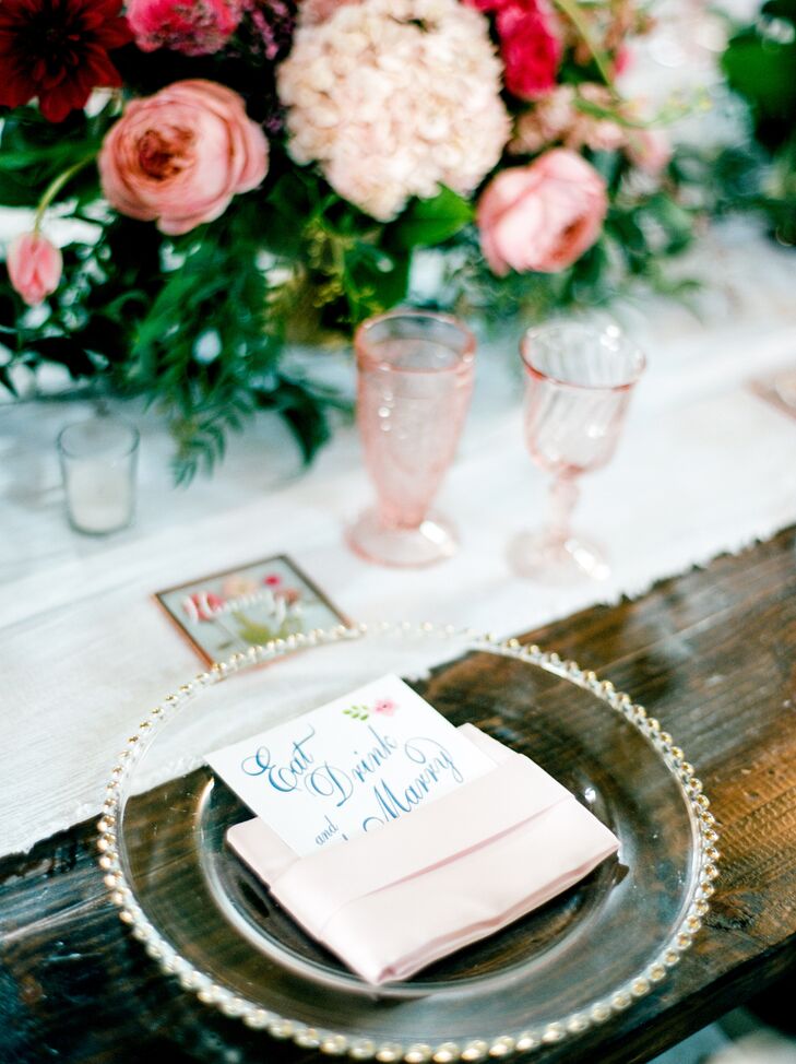 Blush pink glassware and ranunculus were paired with the rich, leafy green centerpieces. Each guest took home a hand-pressed floral coaster.