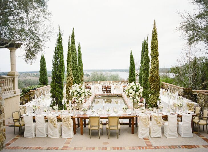 Cyprus trees and sweeping views of the water gave the reception a Tuscan-inspired feel. The long farm tables were arranged around a long reflecting pool that would enhance the romantic ambiance of the space as the sun began to set.