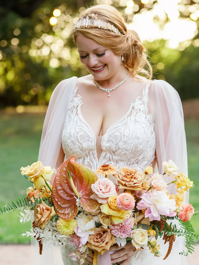 Bride holding orange bouquet