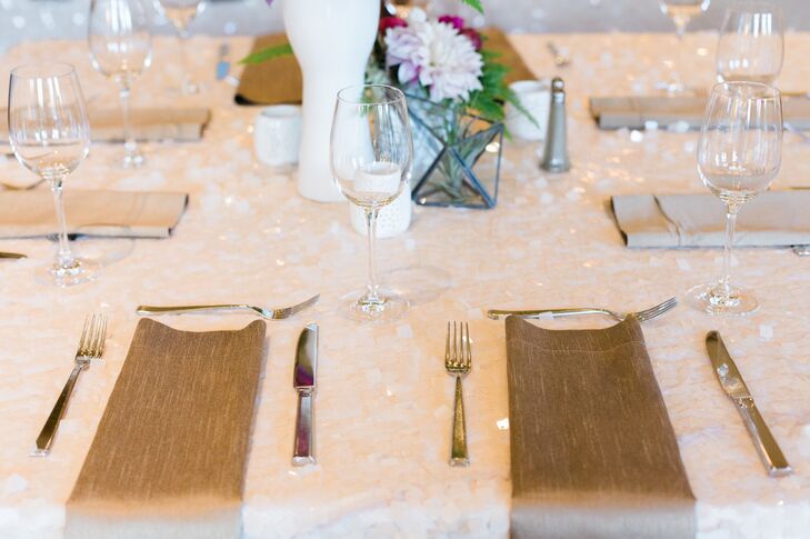 Gilded linen napkins topped pale gold sequined linens at some of the reception tables.