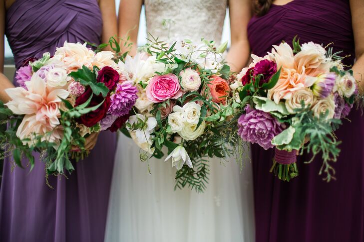 Laura and her bridesmaids carried lush, generous bouquets made to look “soft, textural and a little bit wild.” Each included garden roses, dahlias and passion vines.