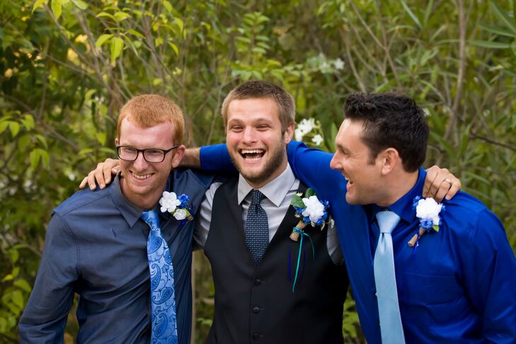 Christian wore a dark blue vest with a silver collared dress shirt underneath, accented with a blue tie that went along with the color scheme. His groomsmen stood beside him, wearing collared shirts and ties that were blue as well.