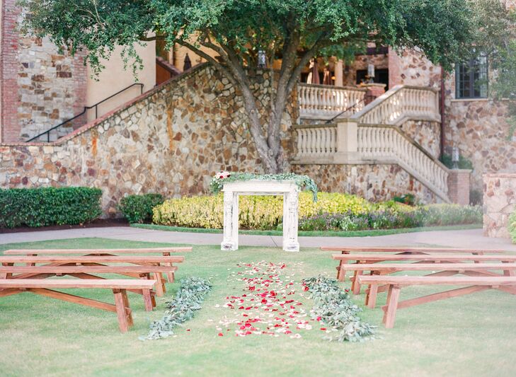 Michelle and Michael had an intimate outdoor ceremony complementing the venue’s natural greenery. They decorated with simple wooden benches, a white vintage mantle as well as garden roses, rose petals and eucalyptus. “I chose the tree as a backdrop of the ceremony, because I love how the green of the leaves photographs,” says Michelle.