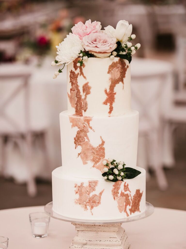 three-tier fall wedding cake decorated with rose gold abstract design and pink roses