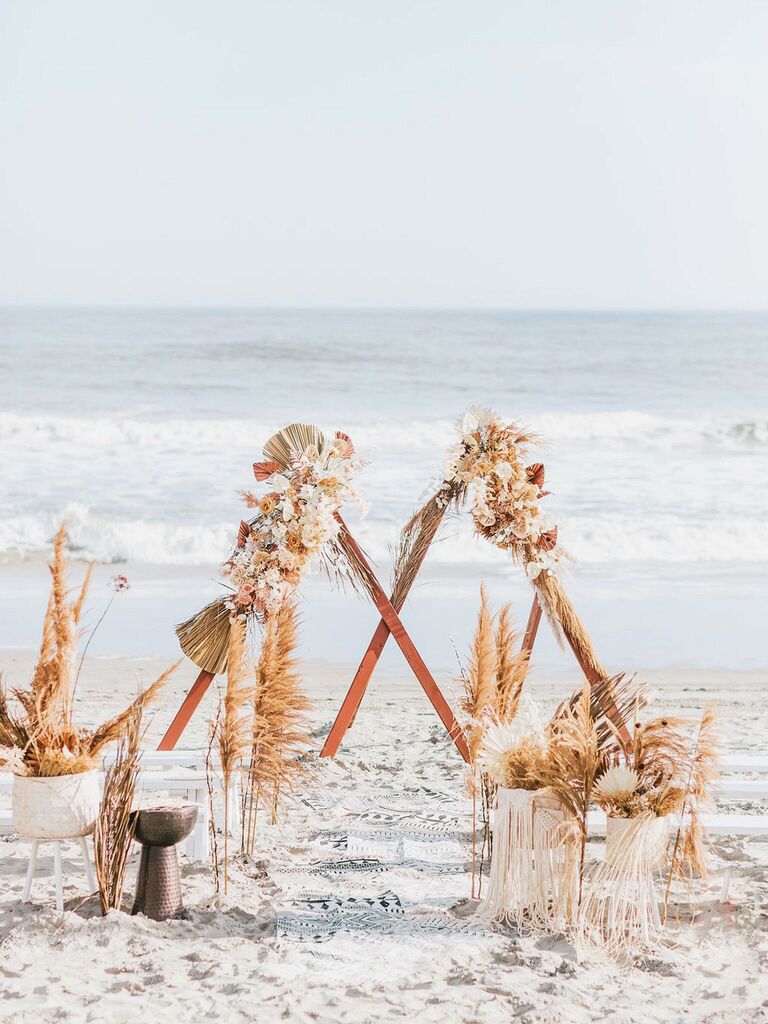 beach alternative wedding arch with triangle backdrop and dried flowers