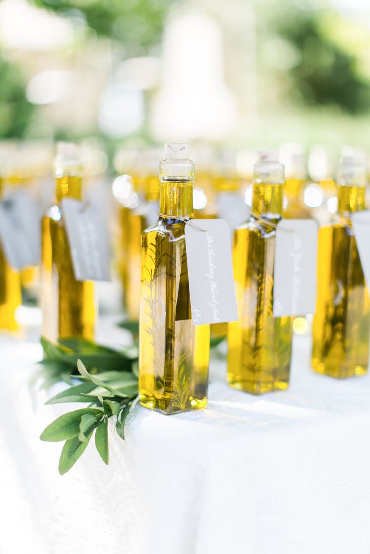 "Our favors were rosemary-infused olive oil bottles and individual olive loaves from a local bakery. I loved the idea of doubling the olive oil bottles as escort cards, having guests find their bottle, and then be greeted at their seat by a pairing loaf. Personalized menus also doubled as place cards," says Anne.

