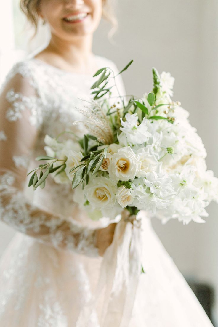 Bride holding white-and-green bouquet