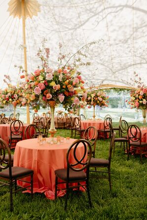Tented Wedding Reception With Tall Centerpieces and Orange Linens