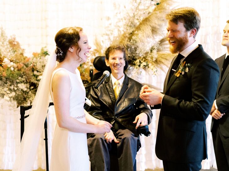Bride and Groom Exchanging Vows in Front of Officiant