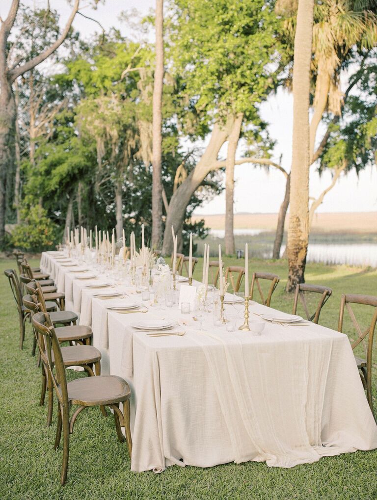 Neutral waterfront tablescape with wood cross-back chairs