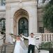 Stylized Action Photo of Bride and Groom in Casual Wear Walking Down Street