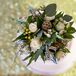 Simply Elegant Floral Designs created this stunning, textured bouquet for Mary Kait to carry down the aisle. It included scabiosa pods, scabiosa blooms, hypericum berries, spray roses, seeded eucalyptus and dusty miller. The soft, muted colors fit the natural wedding theme.