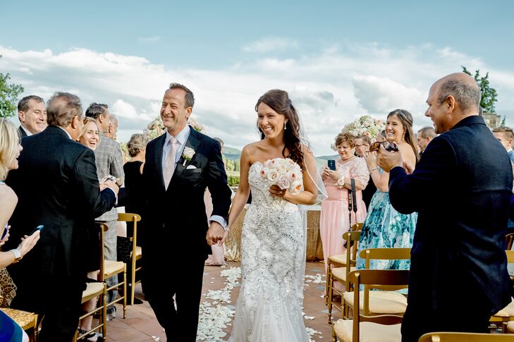 Robert kept things classic, opting for a traditional black tuxedo, which he paired with a blush satin tie for a modern finish. The look complemented the hint of modern glamour reflected in Lindsay’s wedding day look, while respecting the locale's old-world elegance.
