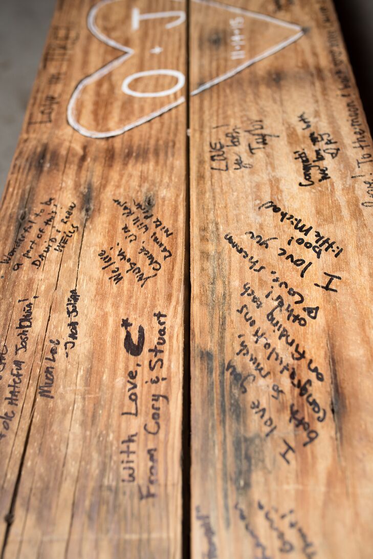 In lieu of a guestbook, the couple had their guests sign a wooden bench, which they sat on at their head table and now have in their home.