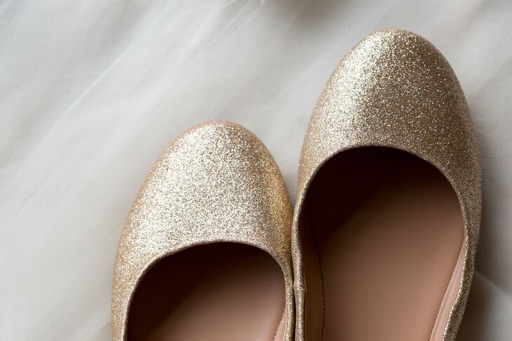 The bride slipped on inexpensive glittery gold flats with her beaded dress.