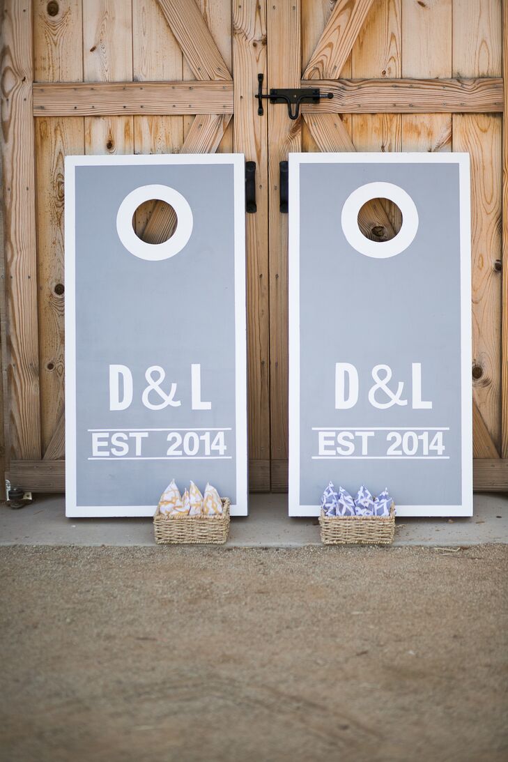 Lauren's siblings contributed to the day's entertainment by building custom gray and white cornhole boards. They personalized the props with Lauren and Drake's initials on the front.