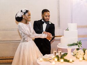 Bride and Groom Cutting White Staircase Wedding Cake