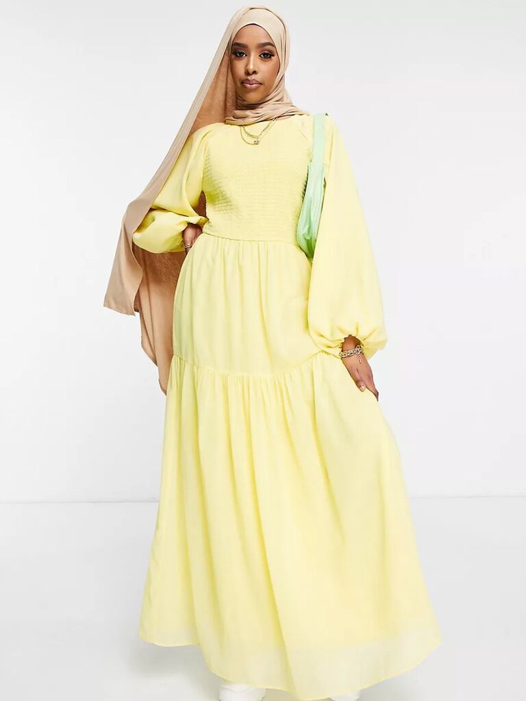 asos light yellow pastel dress for wedding guests with puffy long sleeves high neckline and pleated flowy skirt