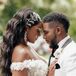 Bride With Wavy Down Hairstyle, Gem Hairpiece and Groom in White-and-Black Tuxedo Embracing