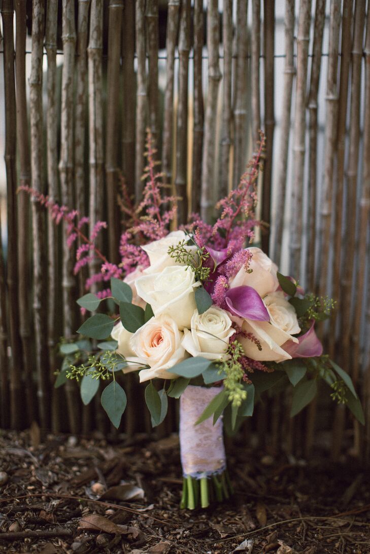 Her bouquet was nothing short of chic. She picked out an organic arrangement from Flowers by Lesley to highlight their natural setting. Ivory roses were paired with pink calla lilies, matching pink astilbes and bold seeded eucalyptus. Every stem was brought together by pink lace and champagne ribbon for a hint of vintage flair.
