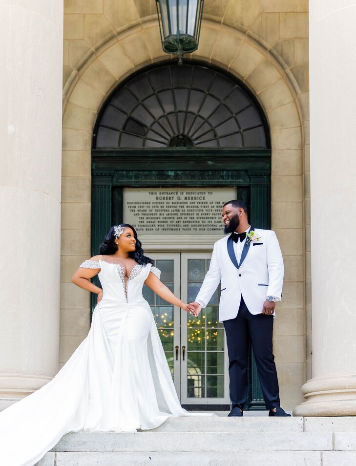 Bride in Fitted Gown, Deep V-Neckline and Overskirt With Groom in White-and-Black Tuxedo, Museum Steps