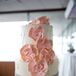 Their wedding cake from Josef's European Pastry Shop was classic on the inside with chocolate and vanilla marble cake. Its decoration, however, was completely different. Every ivory tier was decorated with either Swiss dots, a rhinestone trim, large pink fondant flowers or all three.