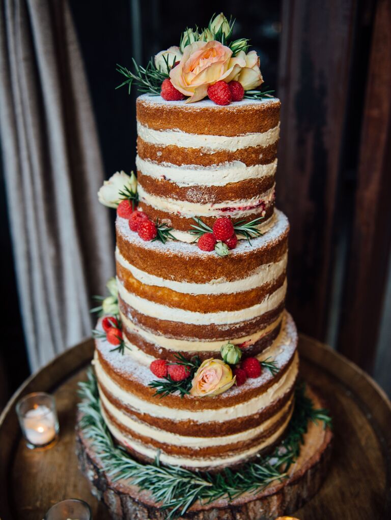 winter naked wedding cake decorated with rosemary leaves and ivory roses