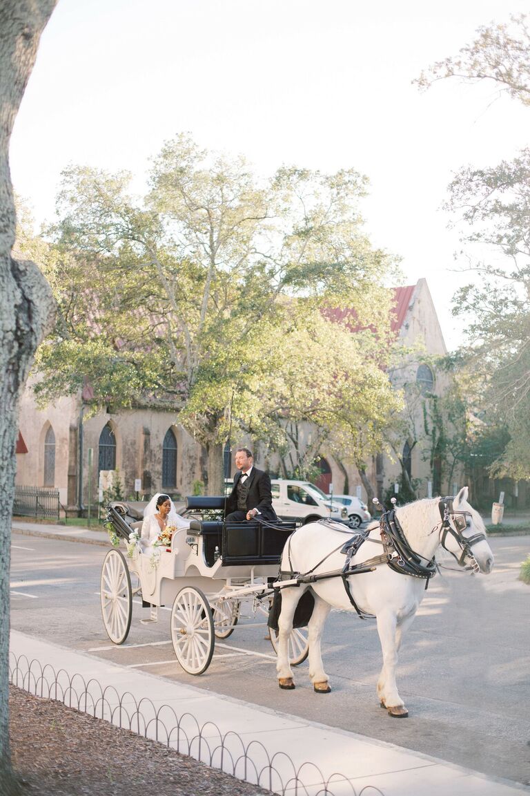 Bride arriving to ceremony in horse-drawn carriage