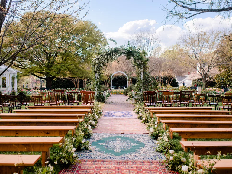 What a wedding arch! Sprays of delicate white flowers and romantic greenery frame the day.