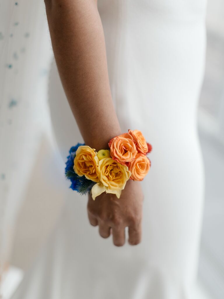 wedding corsage with yellow, orange, red and blue flowers