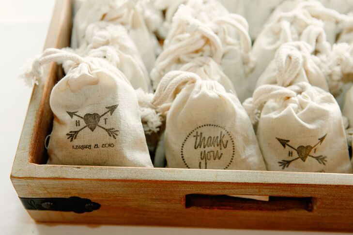 For wedding favors, the bride hand-stamped muslin sachets. One side said “thank you,” and the other was the crossed-arrow wedding logo. The bride filled the sachets with dried lavender, so guests could toss some as Hailey and Tyler made their grand exit and keep some to remember the day.