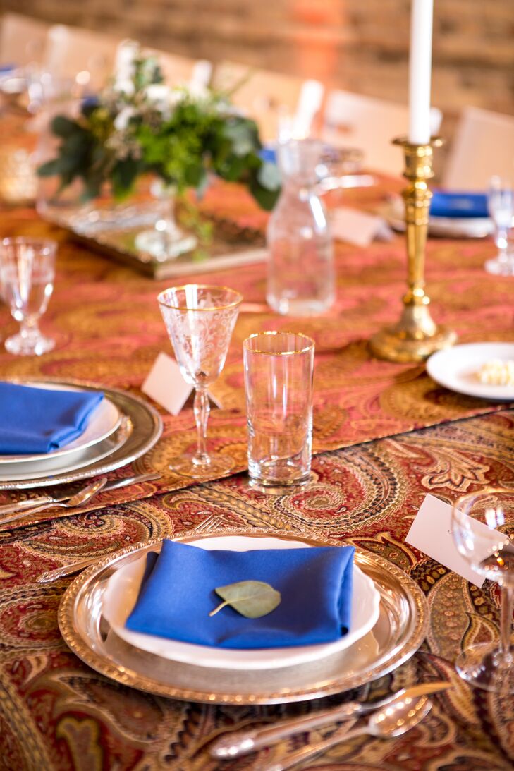 One side of the gallery's second-floor space was dedicated to one long table, set for over 30 guests for the reception. An elegant damask tablecloth covered the table, while white china and silver chargers and ornate brass and silver high candelabras decorated each setting. Fresh flowers and votive candlelight added ambience.