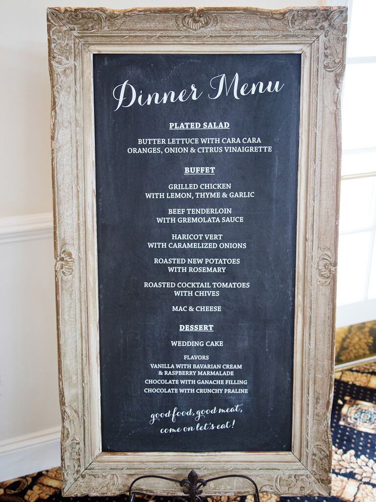 Elegantly framed chalkboard sign with a wedding dinner menu 